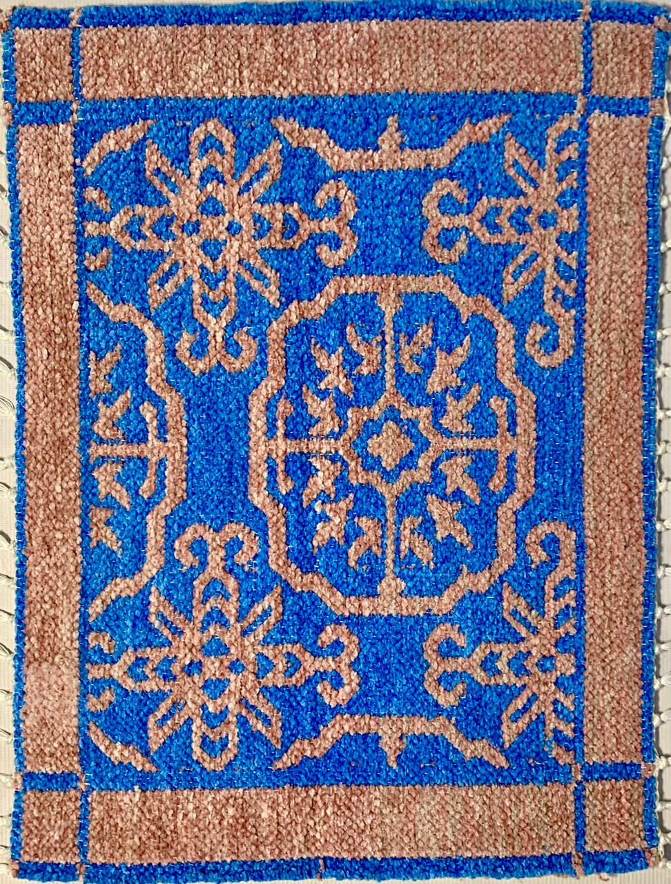 Decorative doormat with blue and brown geometric pattern