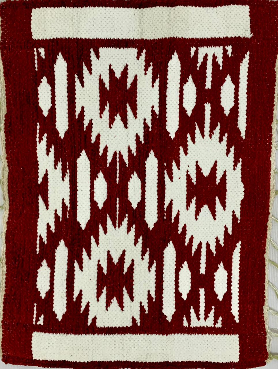 Red and white patterned rug with geometric design