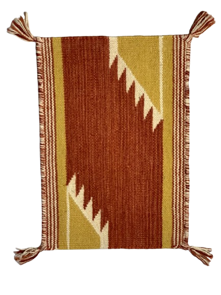 Woven textile with geometric pattern and tassels on a white background
